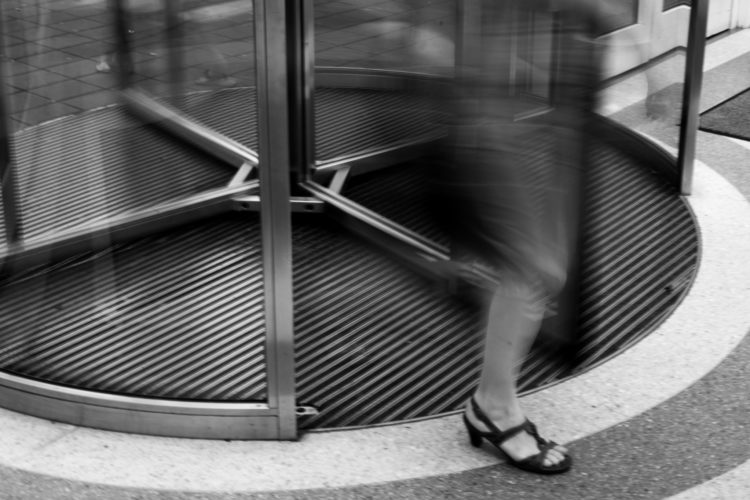 woman exiting revolving door